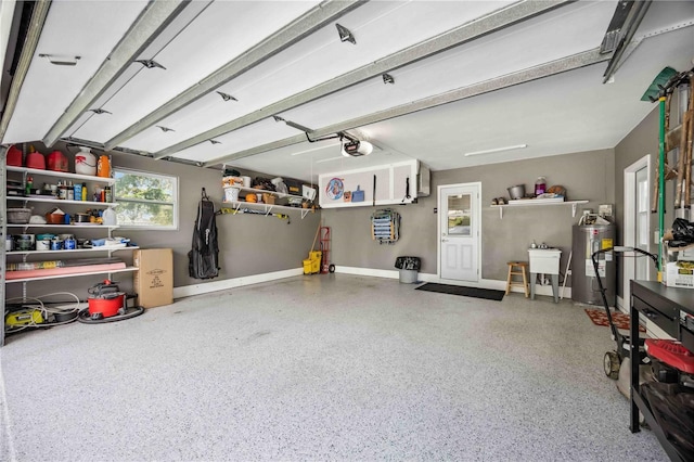 garage with a garage door opener and electric water heater