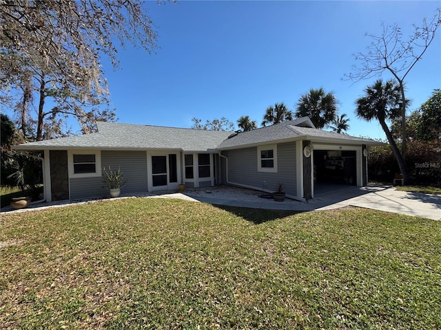 view of front of house with a front yard and a garage