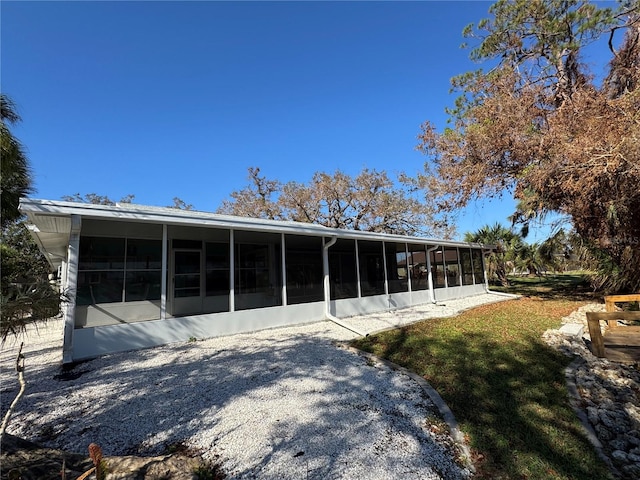 back of house featuring a sunroom