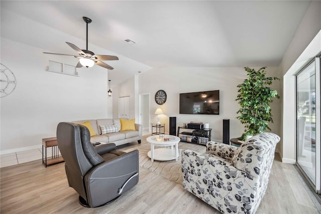 living room featuring light hardwood / wood-style floors, lofted ceiling, and ceiling fan