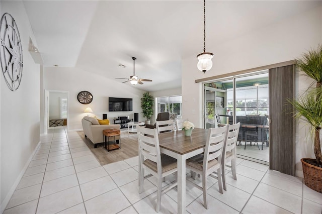 tiled dining room featuring ceiling fan and lofted ceiling