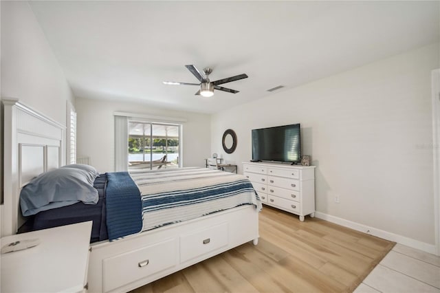 bedroom with light hardwood / wood-style flooring and ceiling fan