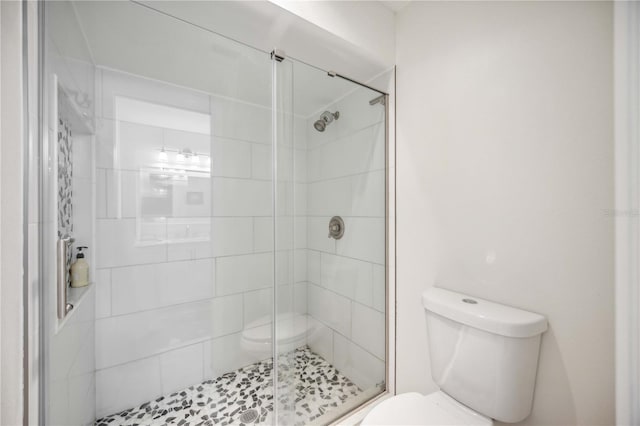 bathroom with toilet and an enclosed shower