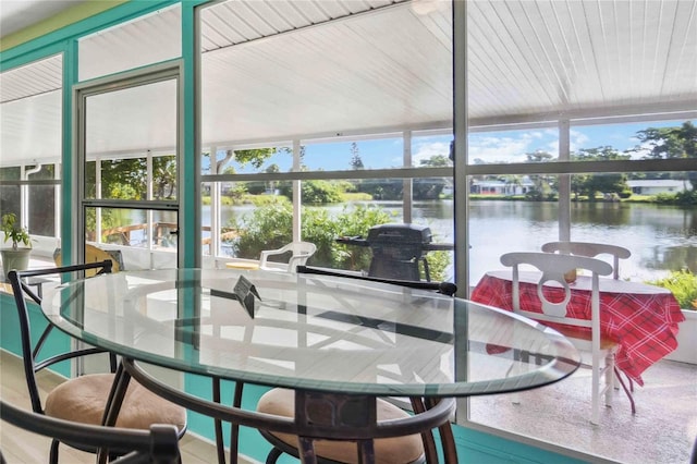 sunroom with a water view and a healthy amount of sunlight