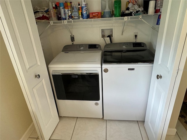 laundry room with light tile patterned floors and separate washer and dryer