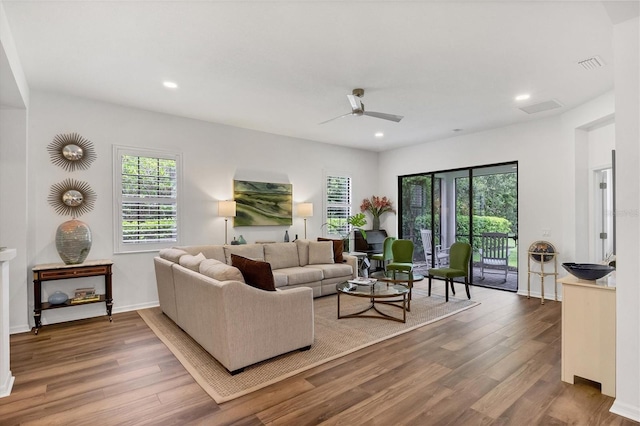 living room featuring a wealth of natural light, recessed lighting, and wood finished floors