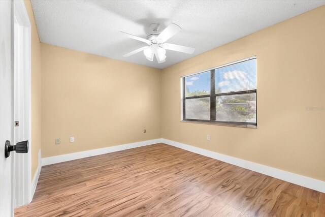 spare room with ceiling fan, a textured ceiling, and light hardwood / wood-style floors