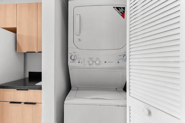 laundry room featuring stacked washer / dryer