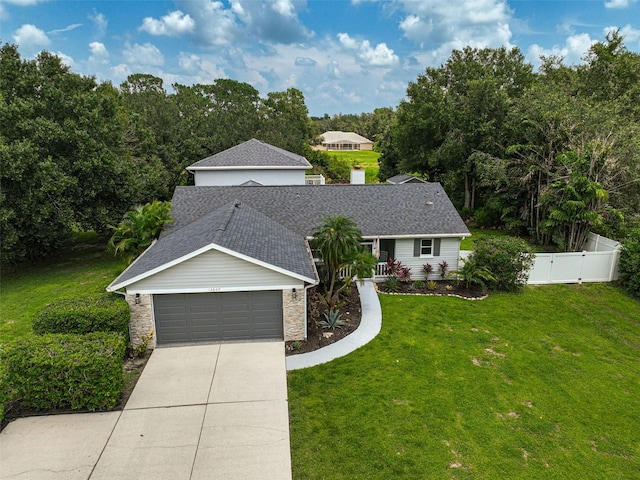 view of front facade featuring a front yard and a garage