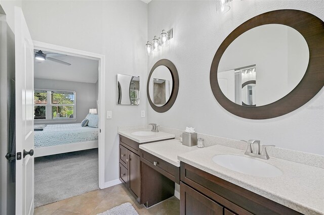 bathroom with tile patterned flooring, vanity, and ceiling fan