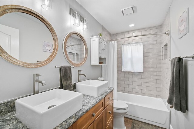 full bathroom featuring vanity, toilet, and shower / tub combo with curtain