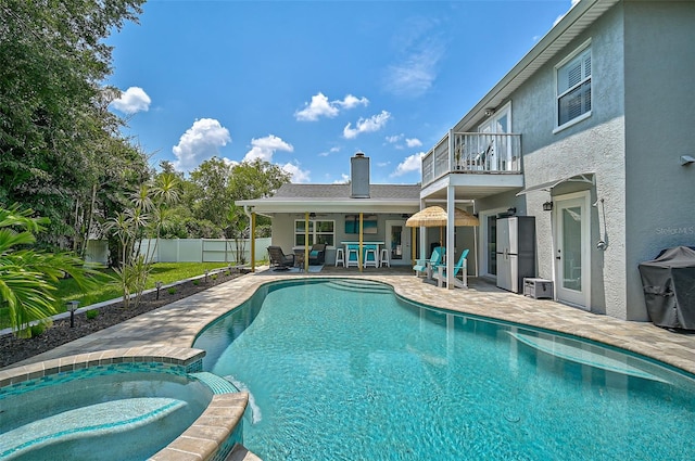 view of pool with a patio area and an in ground hot tub