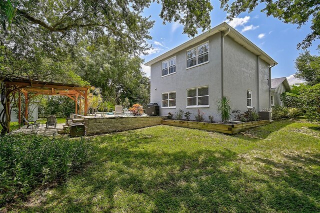 back of property featuring a yard, a pergola, central AC unit, and a patio area