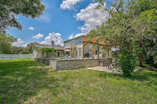 view of yard featuring a patio and a balcony