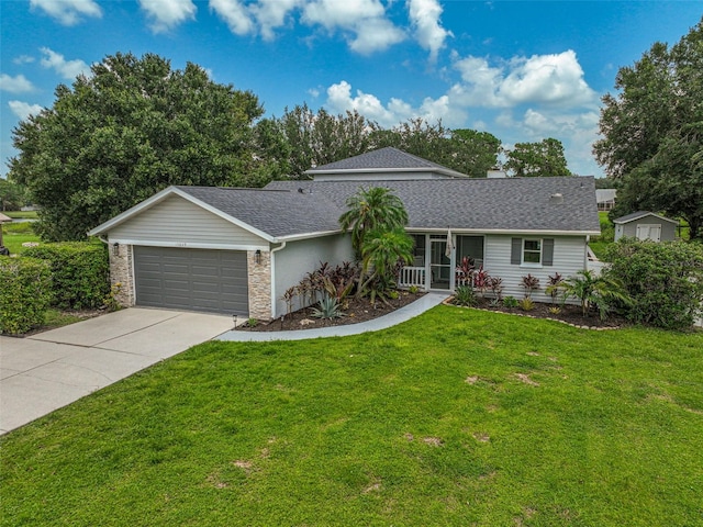 single story home featuring a front lawn and a garage