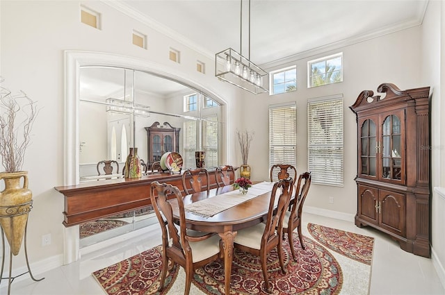 dining space with light tile patterned floors, an inviting chandelier, and ornamental molding