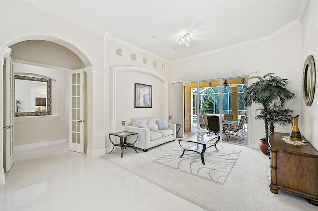 living room featuring crown molding and decorative columns