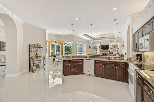 kitchen featuring sink, crown molding, decorative light fixtures, white appliances, and ceiling fan with notable chandelier