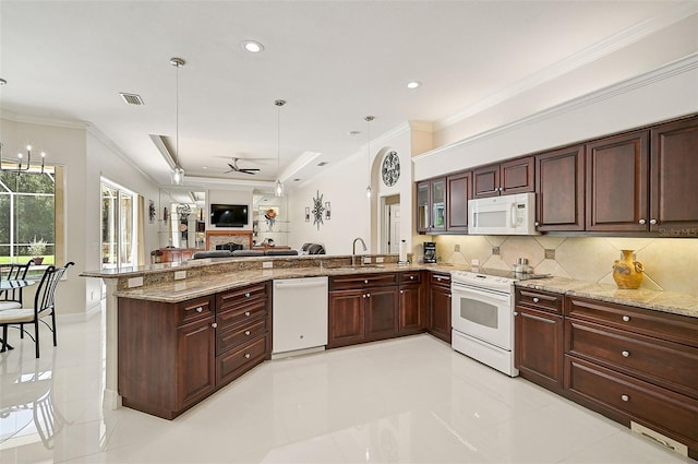 kitchen with sink, hanging light fixtures, kitchen peninsula, white appliances, and ceiling fan with notable chandelier