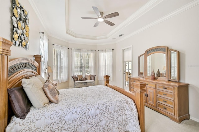 bedroom with ceiling fan, a raised ceiling, light colored carpet, and crown molding