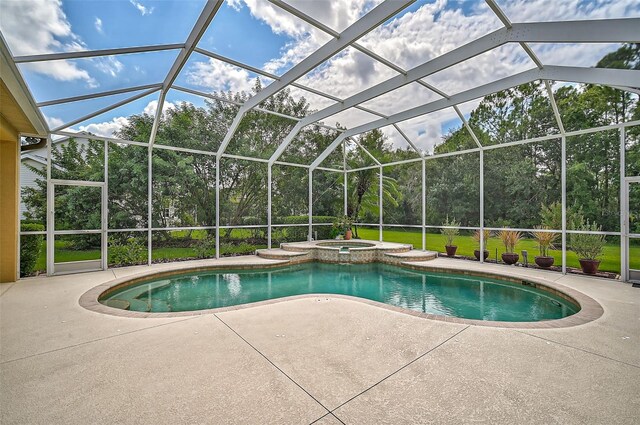 view of swimming pool featuring glass enclosure, an in ground hot tub, and a patio