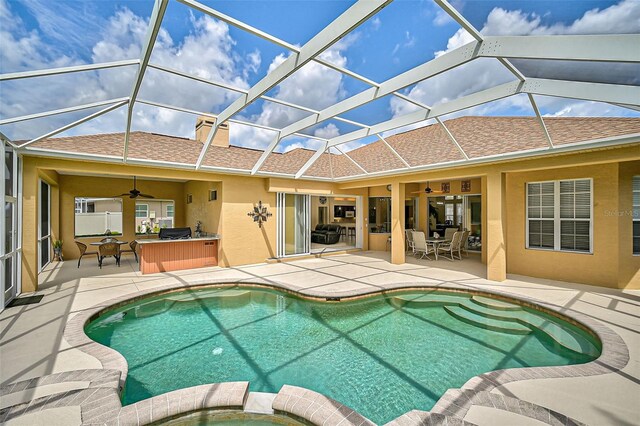 view of pool with a patio, ceiling fan, and a lanai