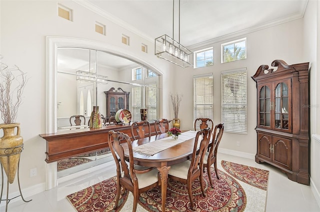 14526 17th Ave E, Bradenton, FL 34212 - tiled dining area with crown molding, a chandelier, and baseboards
