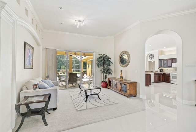 14526 17th Ave E, Bradenton, FL 34212 - living area featuring arched walkways, ornamental molding, light carpet, and baseboards