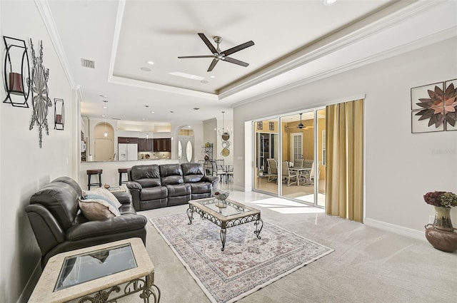 14526 17th Ave E, Bradenton, FL 34212 - living area featuring ceiling fan, arched walkways, a raised ceiling, recessed lighting, and light carpet