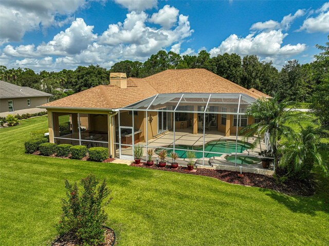 14526 17th Ave E, Bradenton, FL 34212 - rear view of house with a patio area, a chimney, a yard, a pool with connected hot tub, and glass enclosure