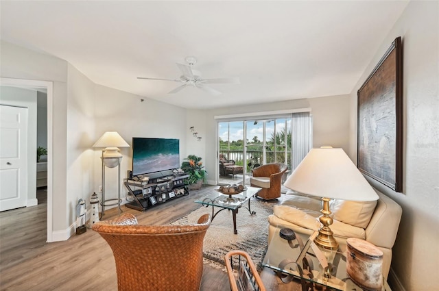 living room featuring ceiling fan and light wood-type flooring