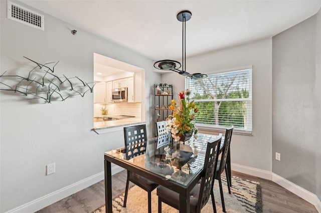 dining space with hardwood / wood-style flooring