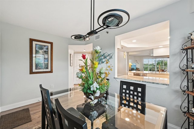 dining area with wood-type flooring