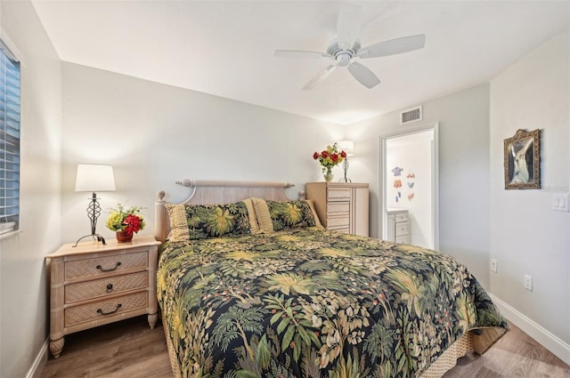 bedroom with hardwood / wood-style flooring, connected bathroom, and ceiling fan