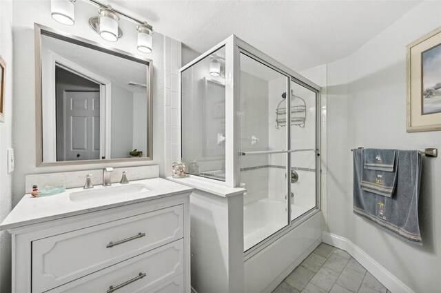 bathroom with vanity and bath / shower combo with glass door