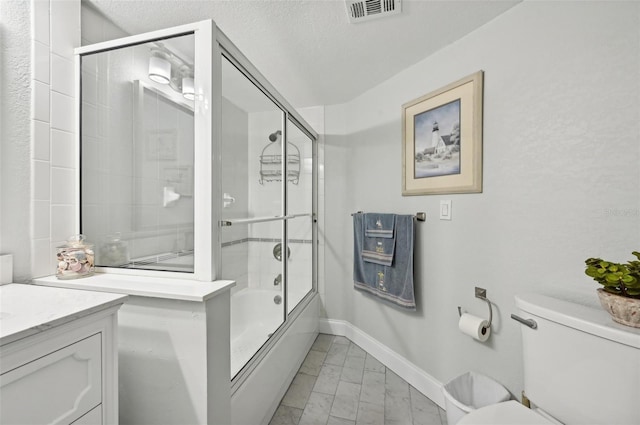 full bathroom featuring toilet, vanity, shower / bath combination with glass door, and a textured ceiling