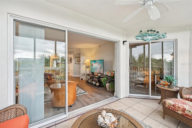 doorway featuring ceiling fan and light hardwood / wood-style floors