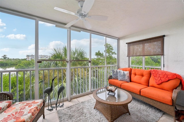 sunroom / solarium featuring a water view and ceiling fan