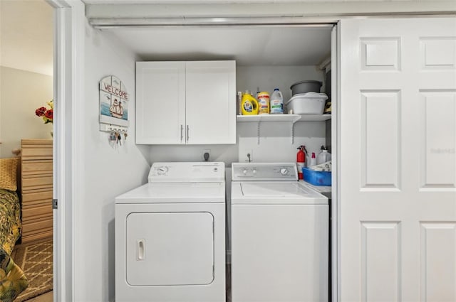 laundry room featuring cabinets and washing machine and dryer