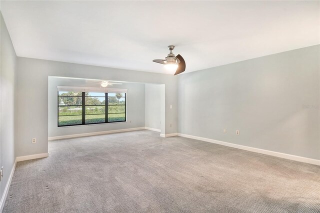 spare room featuring light carpet and ceiling fan