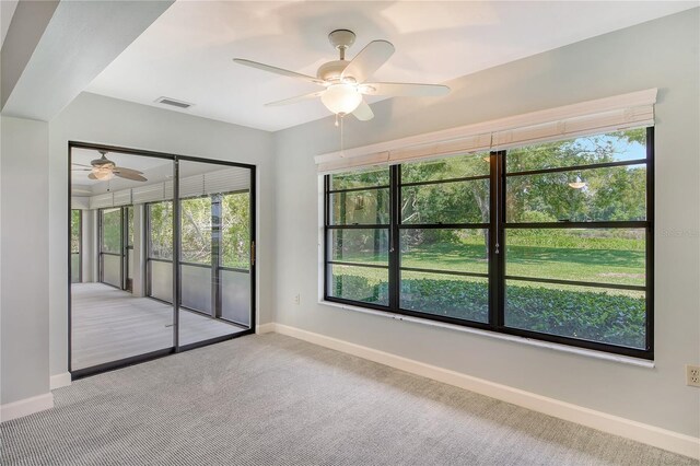 unfurnished room featuring light carpet and ceiling fan