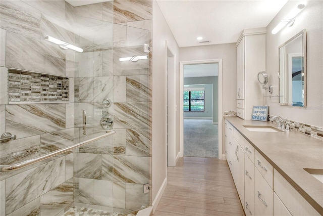 bathroom with an enclosed shower and vanity