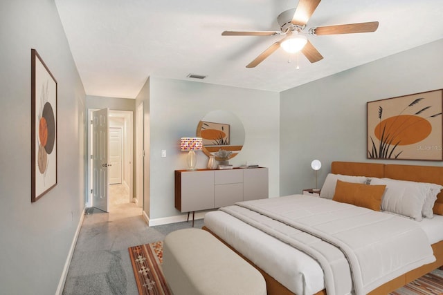 bedroom featuring baseboards, ceiling fan, visible vents, and light colored carpet