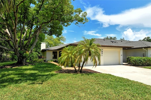 single story home featuring a front yard and a garage