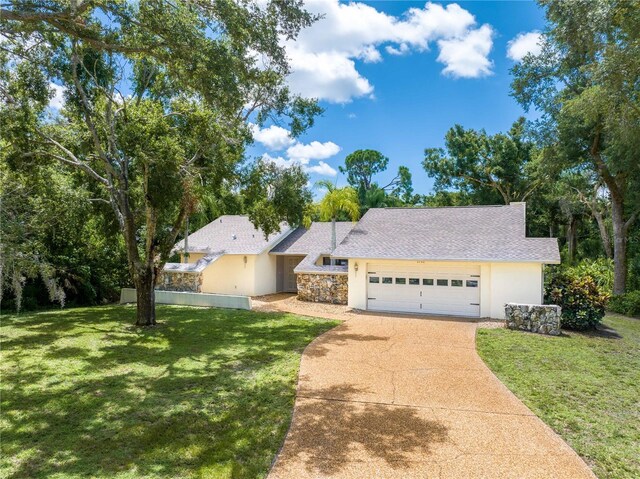 ranch-style home with a garage and a front yard