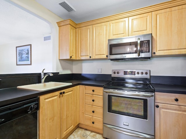 kitchen with light brown cabinetry, sink, appliances with stainless steel finishes, and light tile patterned floors