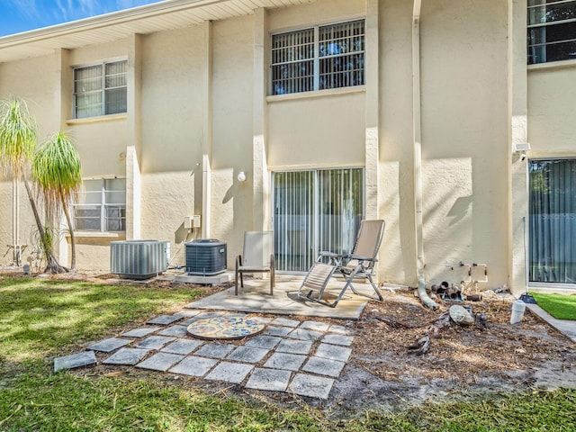 back of property featuring central AC unit and a patio