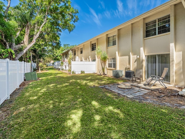 view of yard featuring a patio and central AC unit