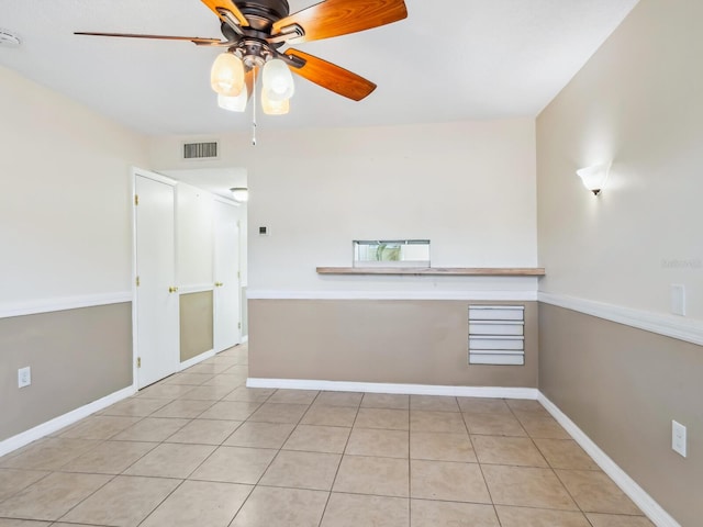 unfurnished room featuring light tile patterned flooring and ceiling fan