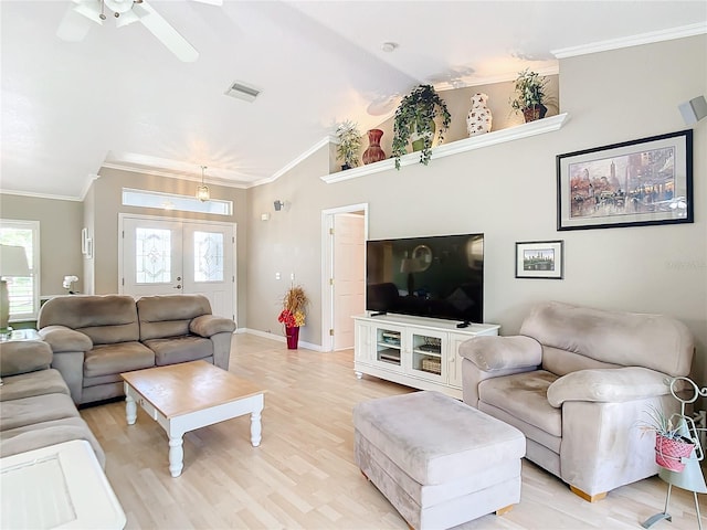 living room featuring light hardwood / wood-style flooring, lofted ceiling, ceiling fan, and crown molding